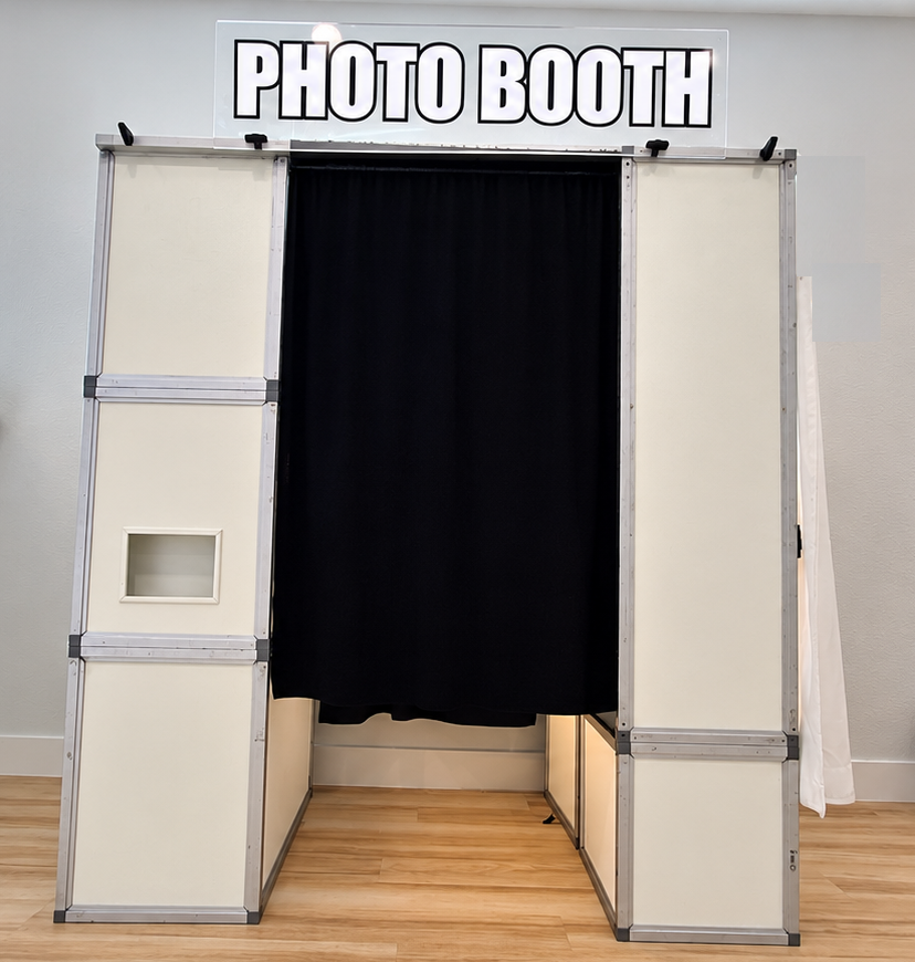 Classic Enclosed Photo Booths of Dallas booth with private curtain and PHOTO BOOTH sign
